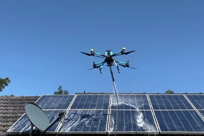 drone flying over rooftop solar panels during eco-friendly cleaning process