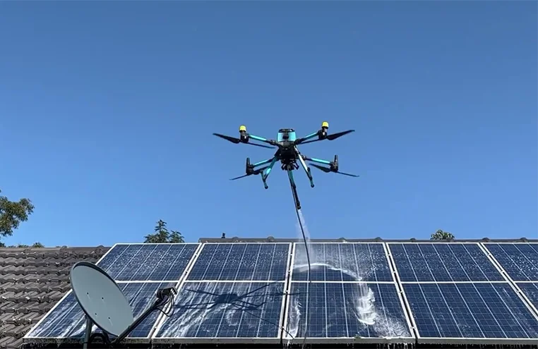 drone flying over rooftop solar panels during eco-friendly cleaning process